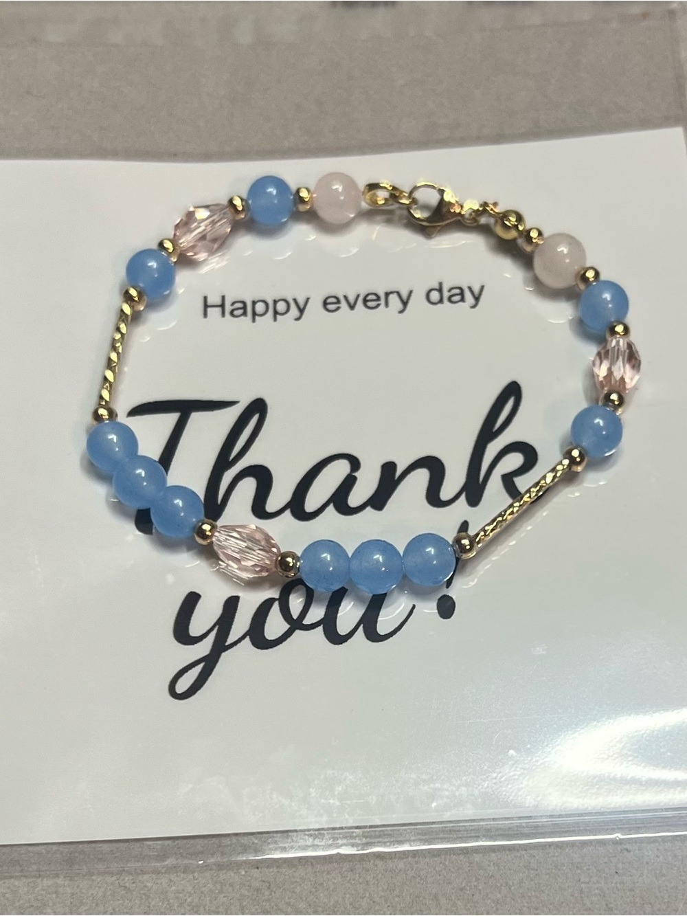 Elegant Gold-Tone Bracelet with Blue Beads and Pink Accents